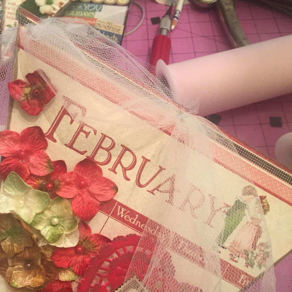 Bring down into the nearest center hole then back up through the other- make sure you pull a little extra out for that puffy look!