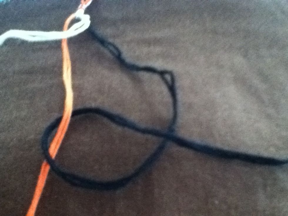 Bring end of thread under center thread and over itself. This is another backward knot. Pull knot to top.
