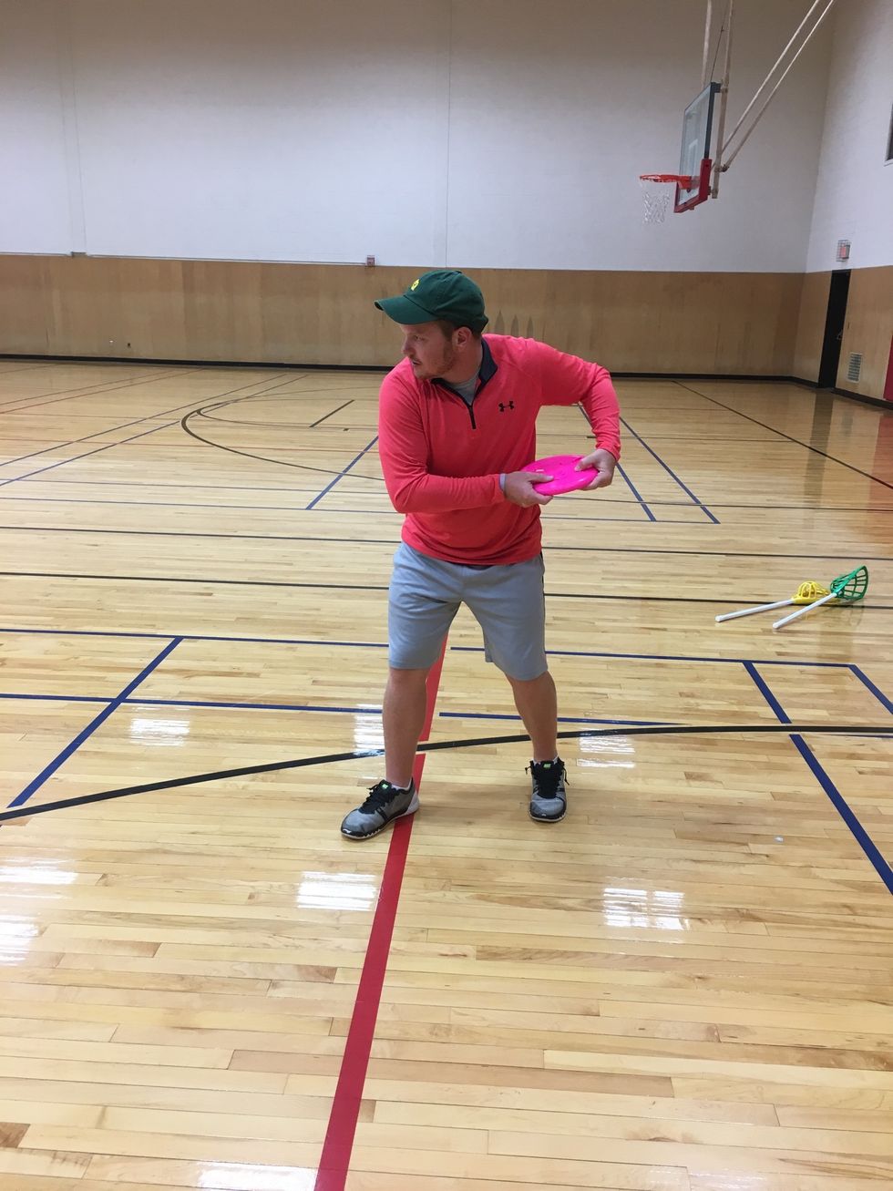 Bring frisbee back and start step towards target