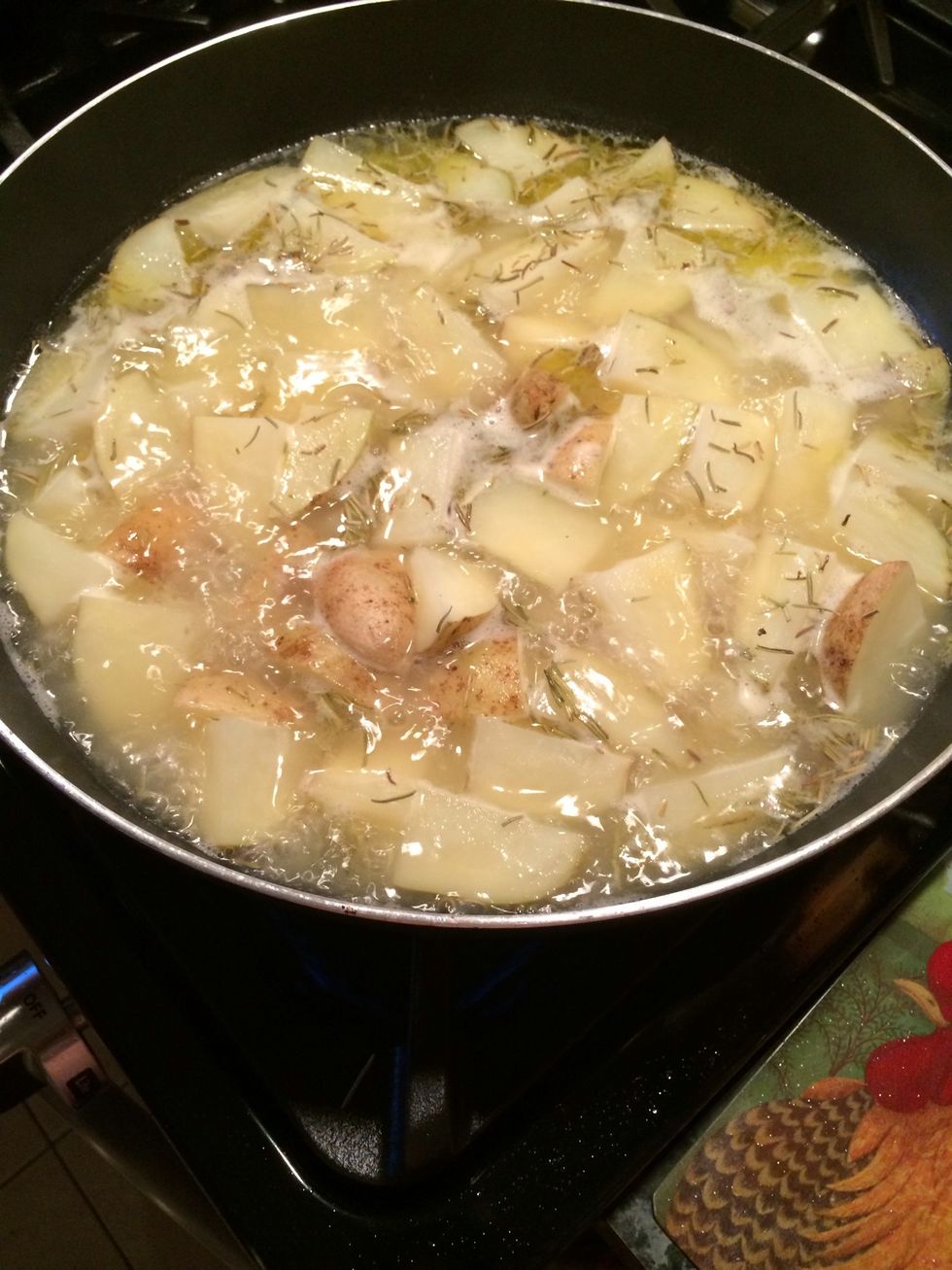 Bring it to a boil. Reduce the heat a little and let it simmer in the chicken broth covered slightly  with a lid until the potatoes are fork tender.