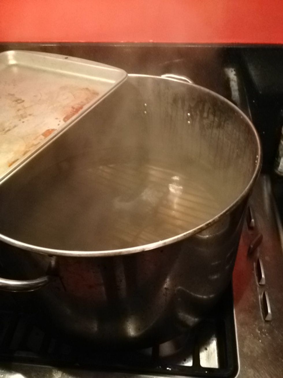 Bring large pot of water to a boil. Line bottom w metal rack or towels to prevent thermal shock to jars.