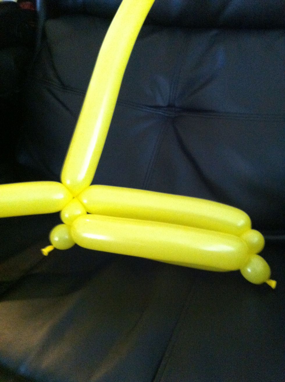 Bring one balloon across and twist into bubble on the other side