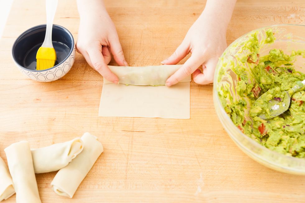 Bring the bottom edge of the wrapper over the filling.