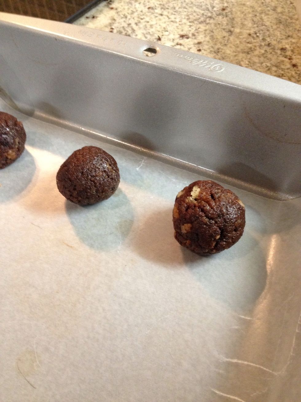 Bring the cake mixture together in your hands and roll into small balls. Place the balls fairly close together on a sheet of wax paper on a baking sheet.