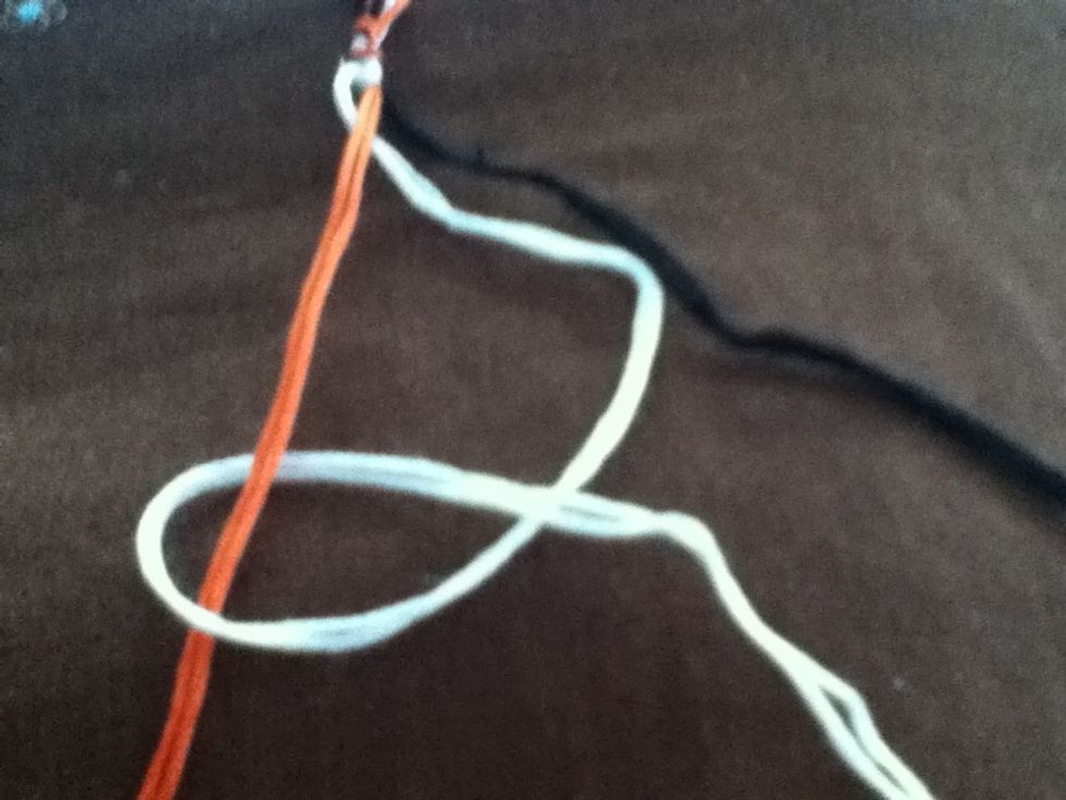 Bring the end of the thread under the center thread and over itself. This is a reverse/backward knot. Being knot firmly to top.