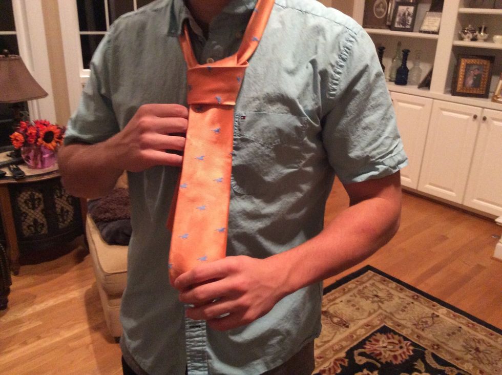 Bring the fat end down through the loop you just made in the front