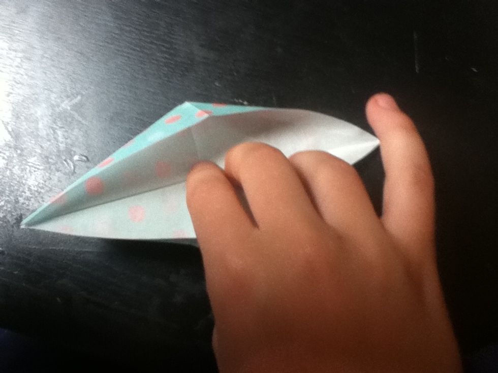 Bring the flap up over the top, and press flat. The sides should start to curve inward.