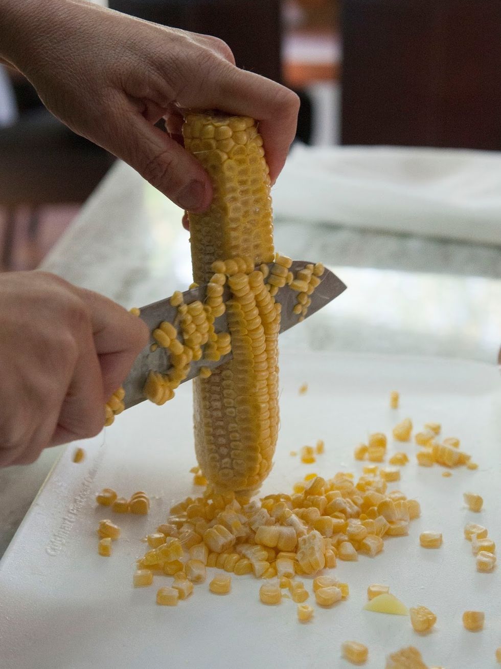 Bring the soup to a boil then turn everything down to simmer. Put a lid on the pot and cook it gently for about 20 minutes or so. Meanwhile, cut the kernels off the corn.