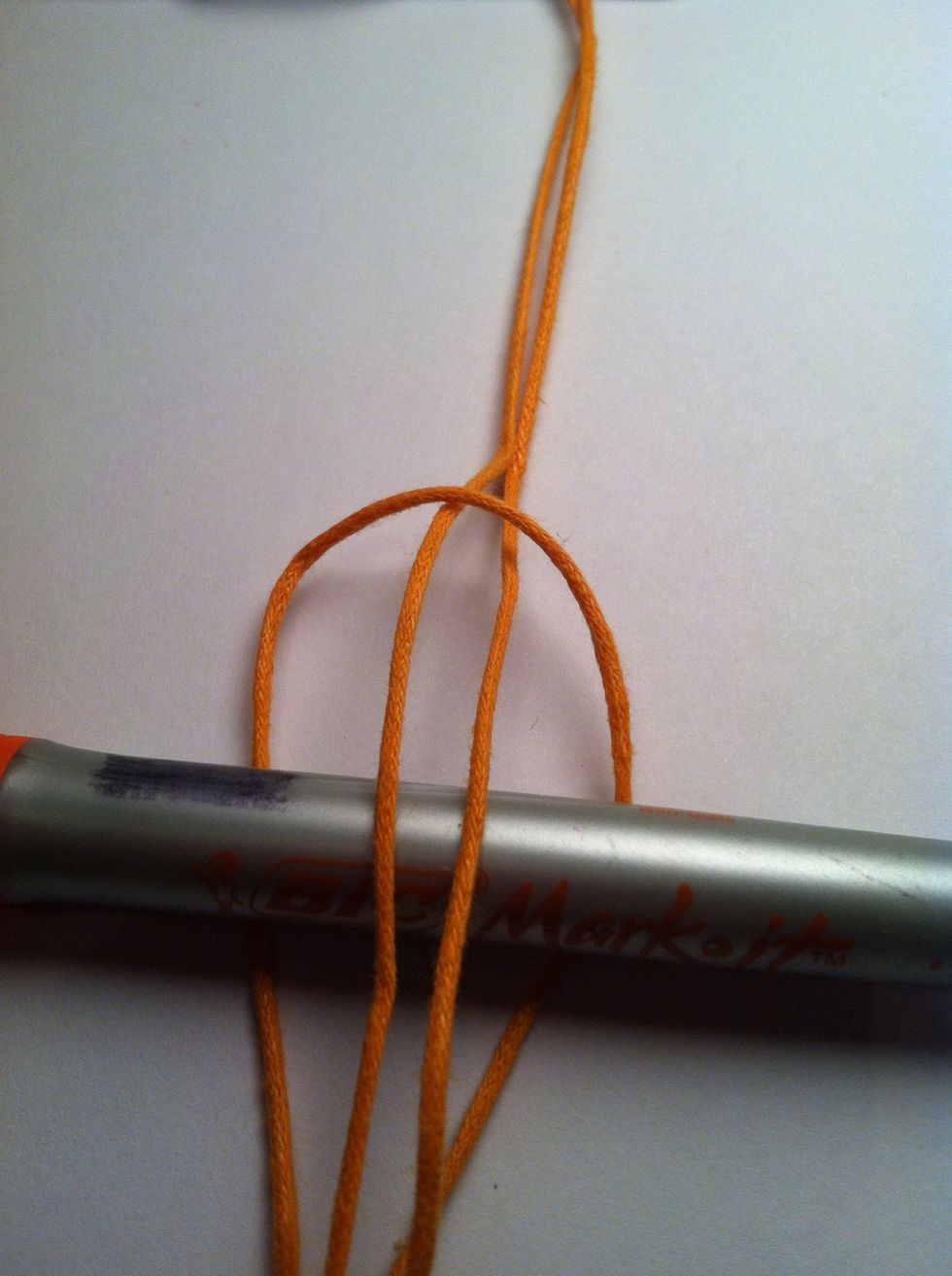 Bring the tails up and over the object and through the loop.