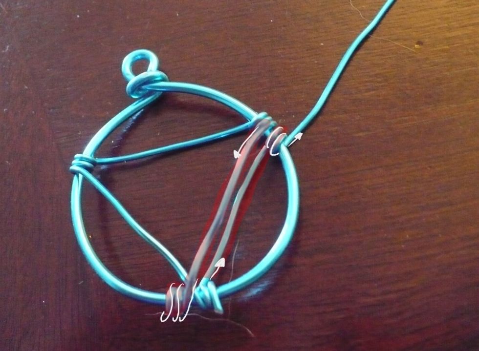 Bring the thin wire over the frame to the bottom and wrap twice, then pull behind to top right... Wrap twice. :)
