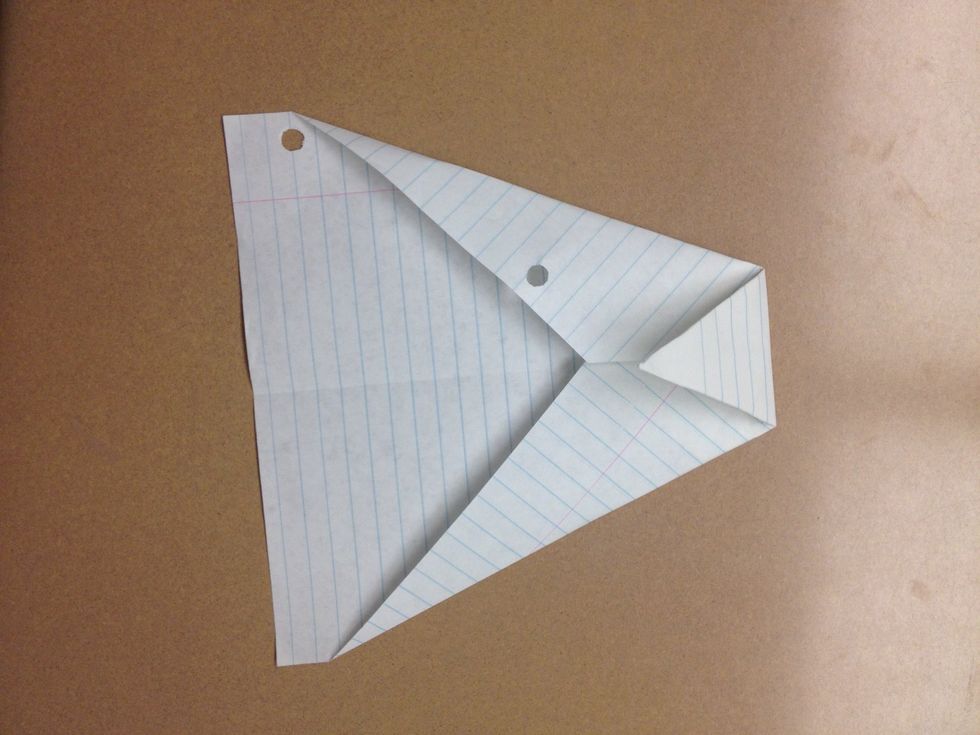 Bring the tip down to the center fold so that it's like a triangle