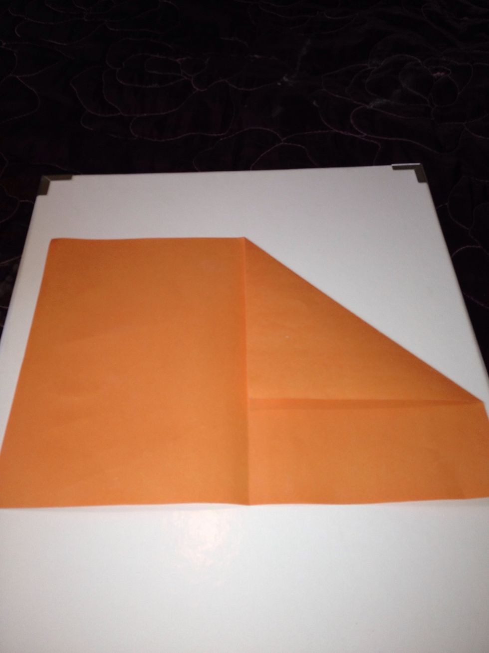 Bring the top right corner to the centre line and create a crease