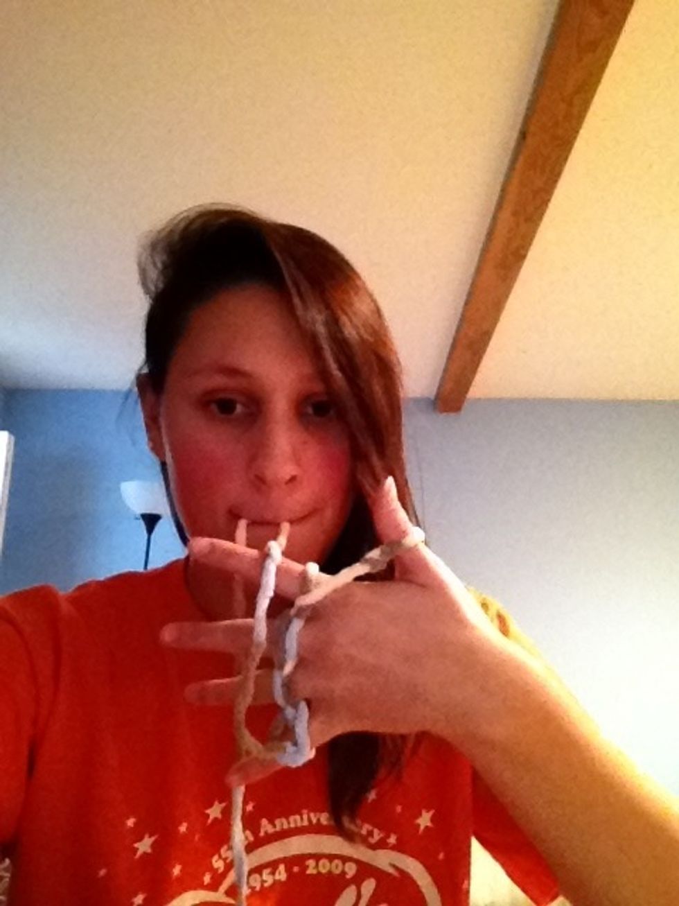 Bring the yarn from your pinkie around your knuckles...