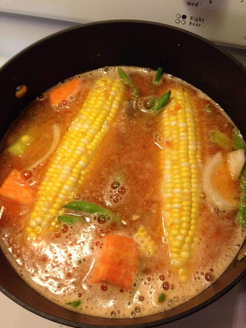 Bring to a boil on high heat. Leave the lid on and turn it with a large spoon from time to time. When it starts to boil lower the heat to med for 10 minutes. Then turn it back on high to drop lobsters