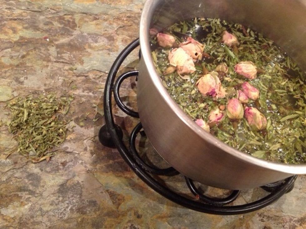 Bring water to boil in a small saucepan and add stevia and rose buds.