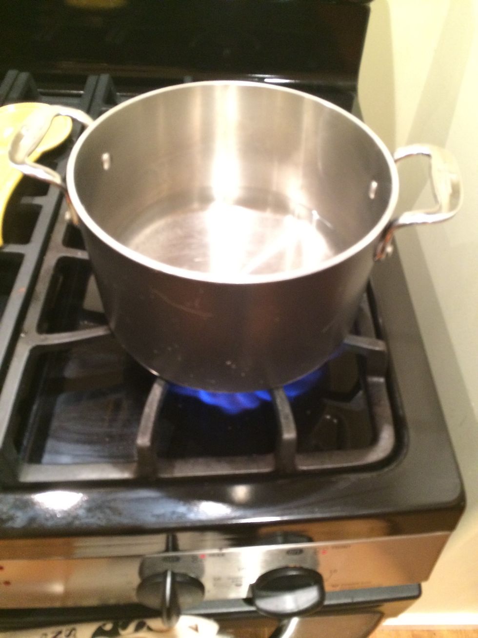 Bring water to simmer in a pot that is an appropriate size to use as the base of a double boiler. The stainless steel bowl with the ingredients will be going on top.