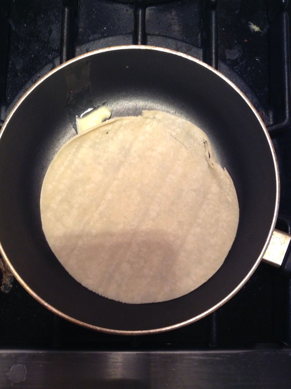 Bring your burner to Med-Low and put your butter in, spread it around and add your tortilla. Cook for 3 min and flip.