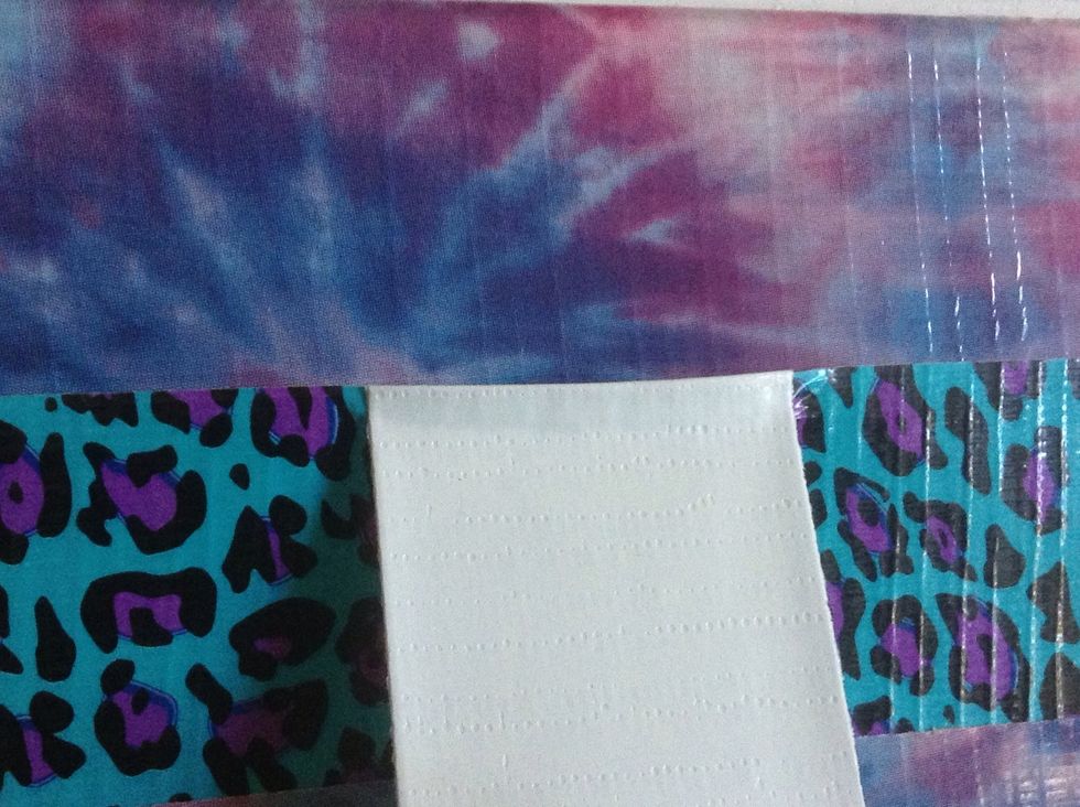 Bring your roll of tape down and, pressing the edge as flat as possible, stick the edge of it so it is flush with the edge of the tape that overlapped it. Only stick it a little bit.