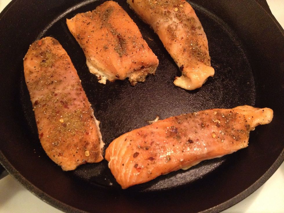Broil the salmon in a skillet, you don't need any oil or butter. Give the fillets some colour and then move it to an oven pan. Cook at 200 degrees C for about 5 minutes.