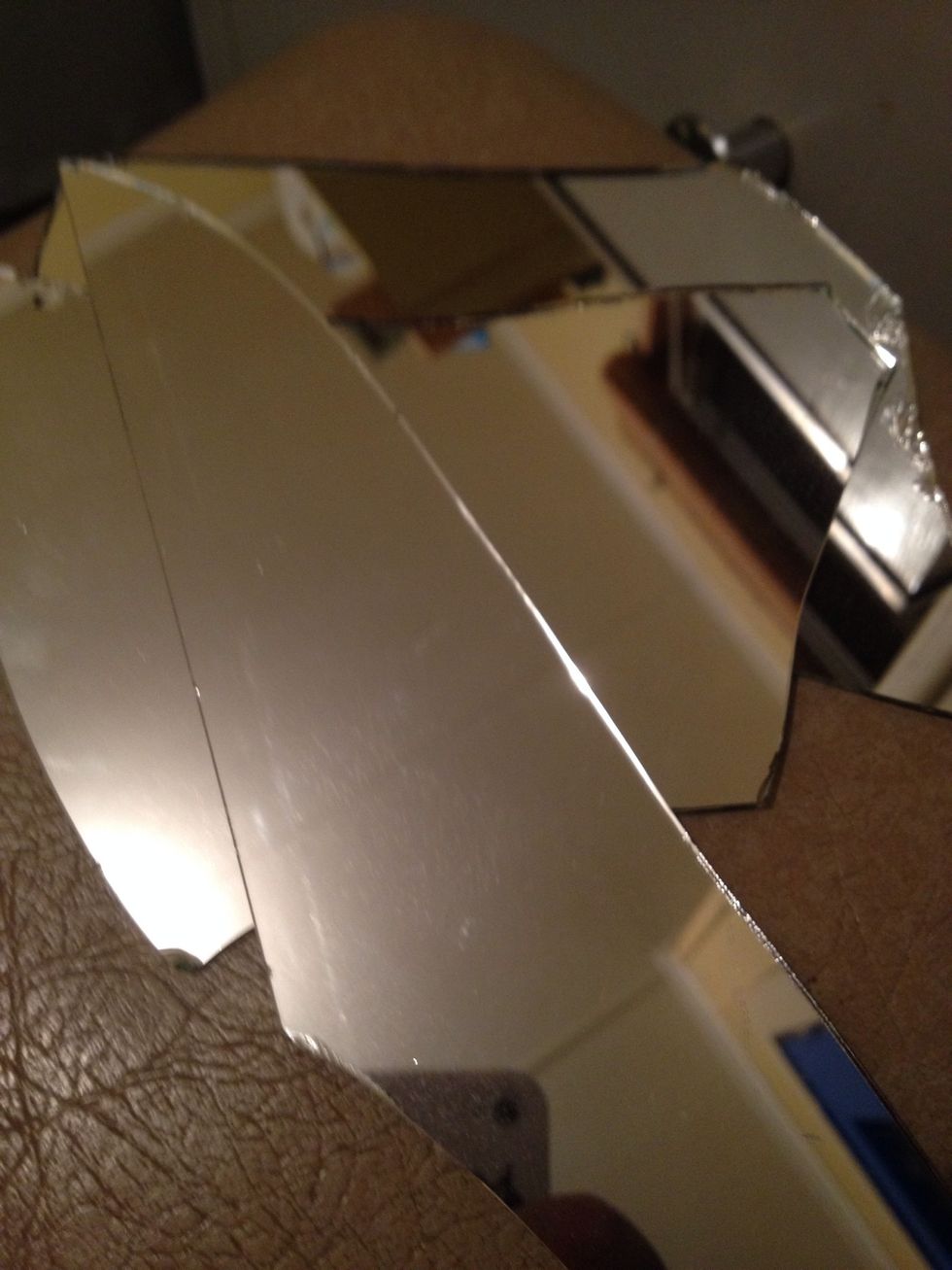 Broken mirrors are such a pain so I decided to upcycle all the shards into a funky wallpiece in my hallway. The glass should be all varying shapes and sizes from breaking.