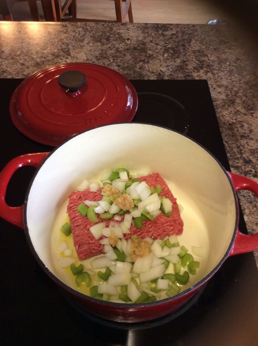 Brown beef, celery, onions, and garlic (preferably) in a Dutch oven on medium-high heat.