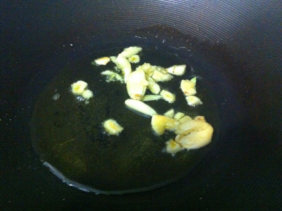 Brown garlic lightly in preheated olive oil