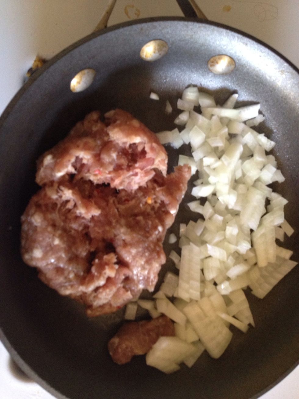 Brown sausage and onions in a skillet over medium-high heat.