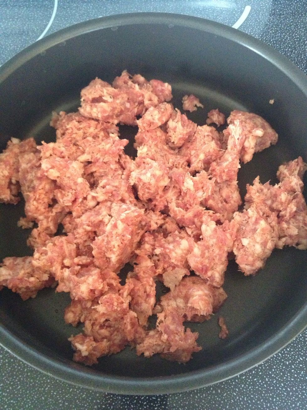 Brown sausage over medium-high heat in a large skillet.