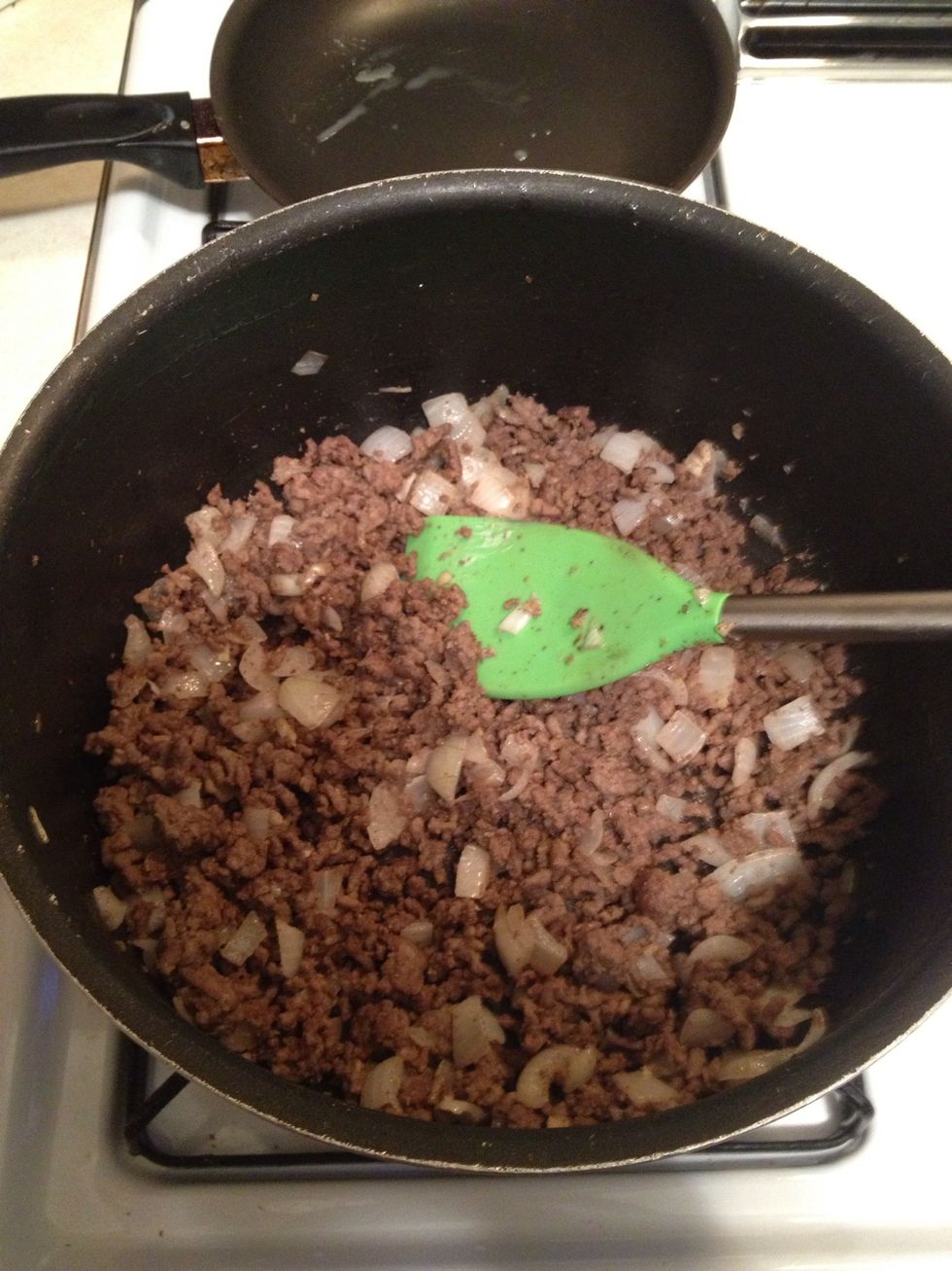 brown the meat and add the onions (add 3 garlic cloves minced with a dash of salt to give it an awesome flavor).
