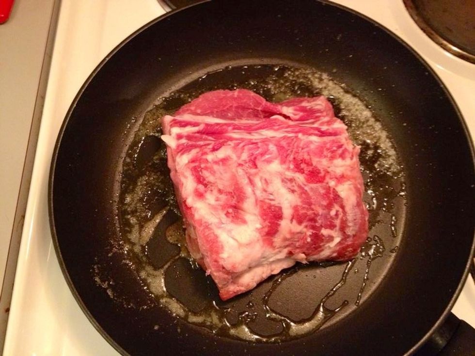Brown the piece of meat on all sides.