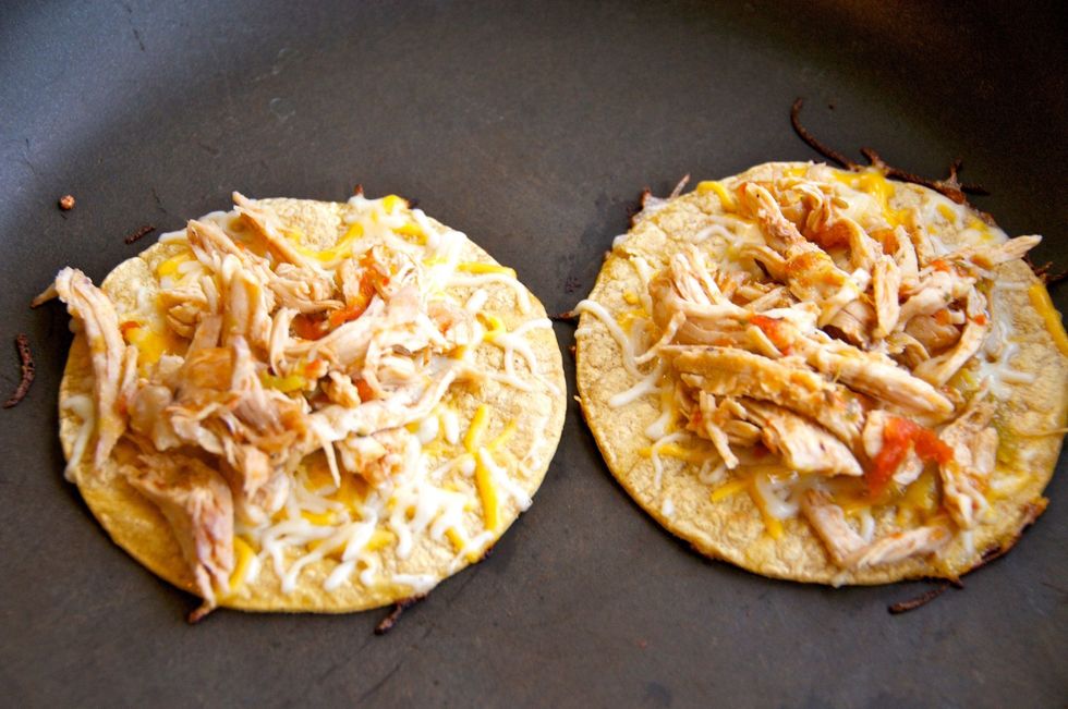 Brown the tortilla on both sides then place a little cheese and about 1/4 cup of shredded chicken on top.  Let the cheese melt before removing from the pan.