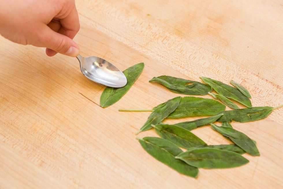 Bruise the sage leaves with the back of a spoon. Then, add it to your syrup mixture.