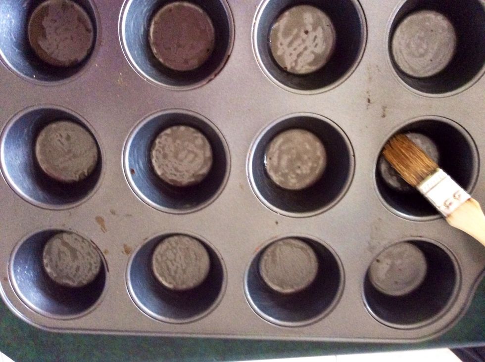 Brush a 12-hole muffin tin with melted butter.
