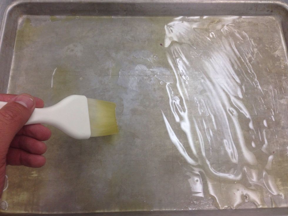 Brush a pan with olive oil.