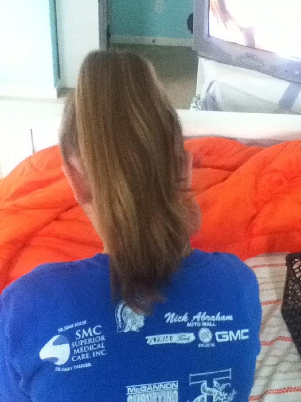 Brush and pull hair into a high pony tail