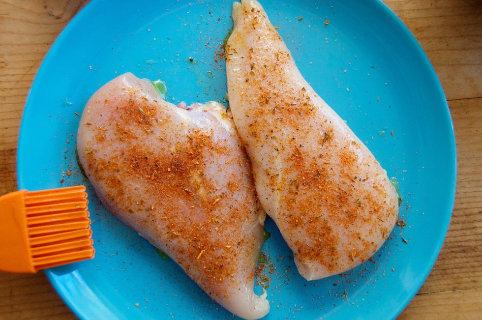 Brush both sides of your chicken with some olive oil.  Take 1/2 tsp. of Smokin' Chipotle seasoning for each breast, and season both sides, using 1 tsp total.  Let it marinate while your oven warms.