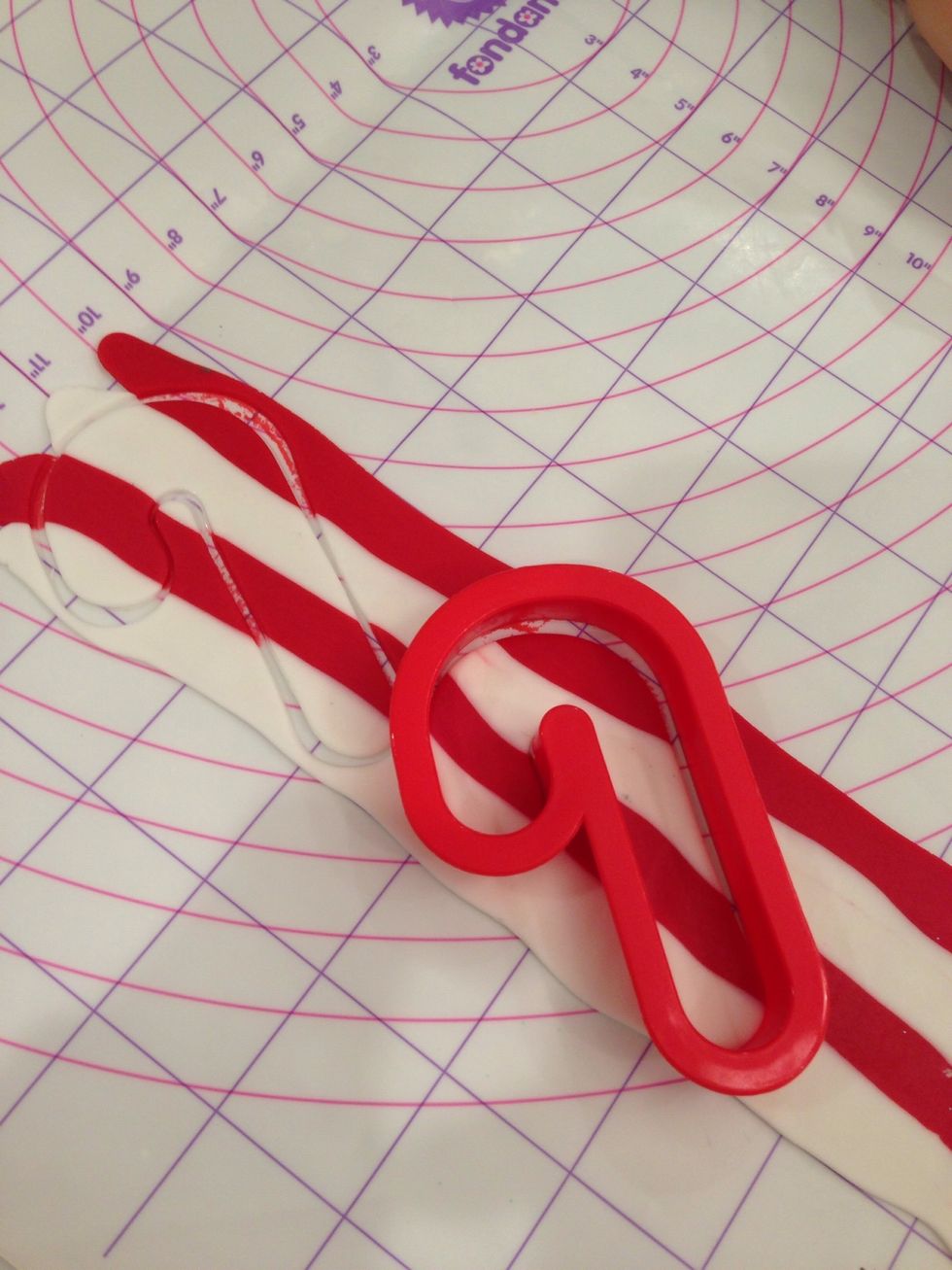 Brush cookie with little water to make fondant stick well. Then patch the matching fondant on the cookie.