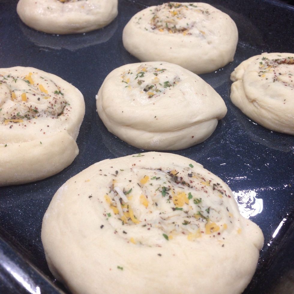 Brush each roll with olive oil, and sprinkle with more cheese. Let rise until slightly puffed, about 20-30 minutes. While waiting preheat the oven to 400 degrees (200 degrees C)