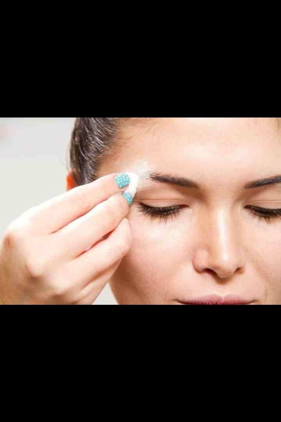 Brush eyebrows upwards with spirt gum, then apply eyebrow wax to the desired are you want to block out with a spatula.