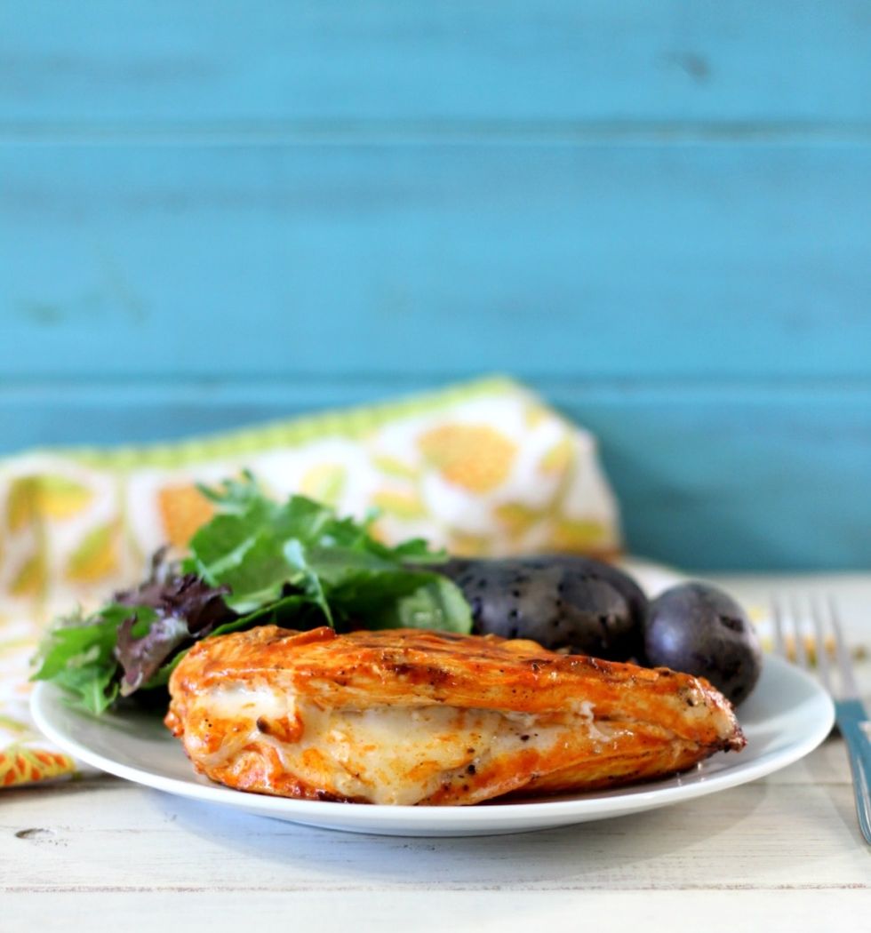 Brush more hot sauce over top of chicken. Cook for about 7 minutes. Flip the chicken and brush on remaining hot sauce and cook until no longer pink; about 5 minutes more.