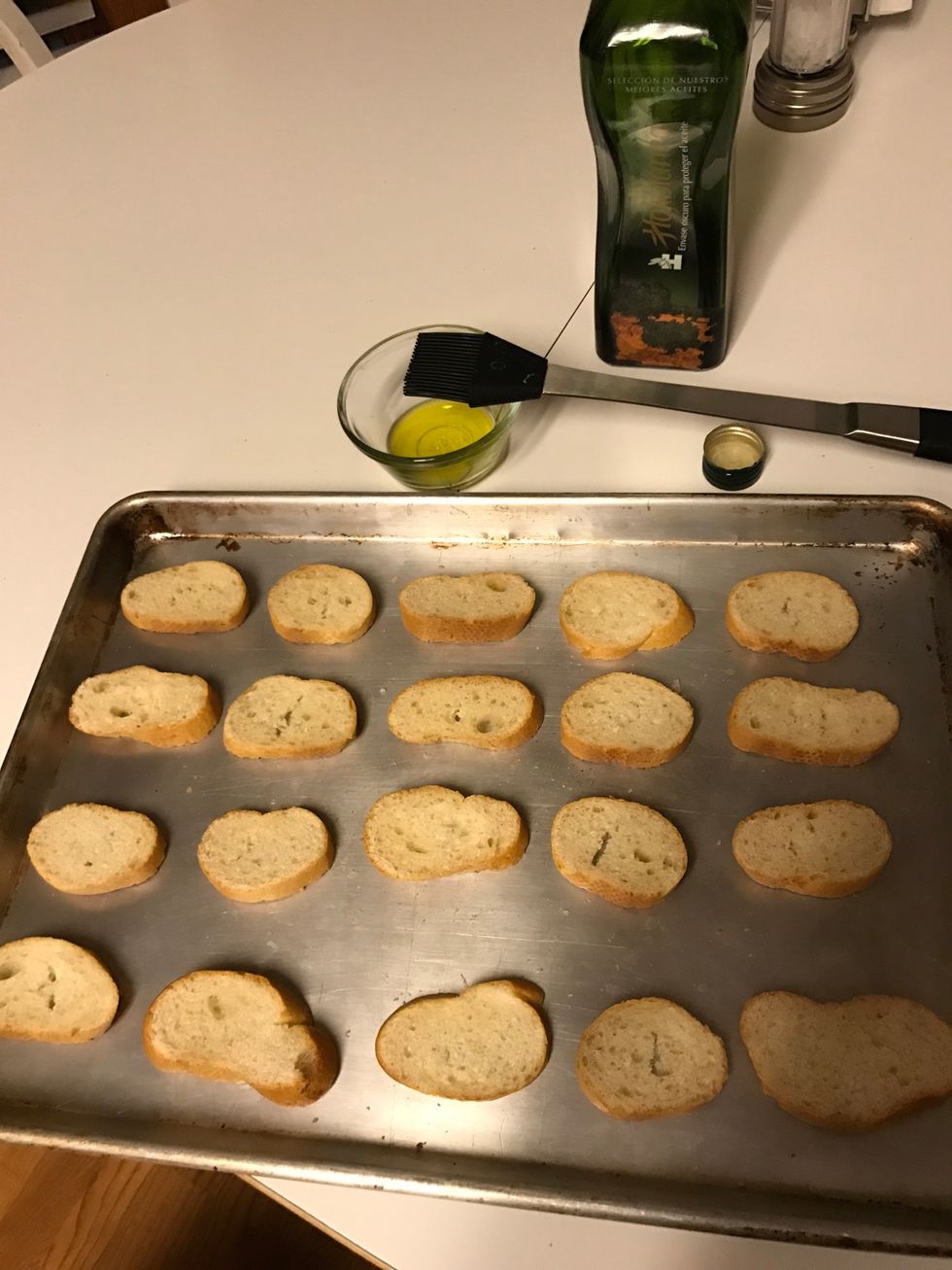 Brush olive oil on bread slices