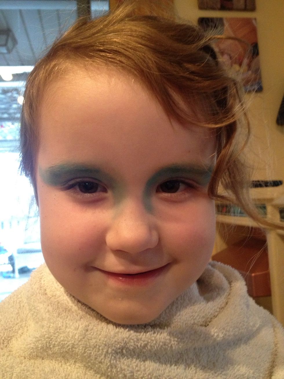 Brush on some blue Mehron INtense Pro pressed pigment powder over the eyelids.