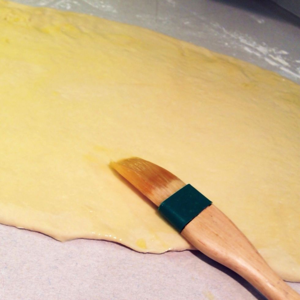 Brush one tablespoon melted butter over the surface of the dough.