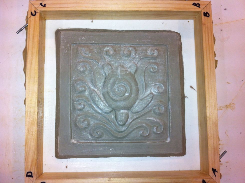 Brush soap or silicone spray over tile surface