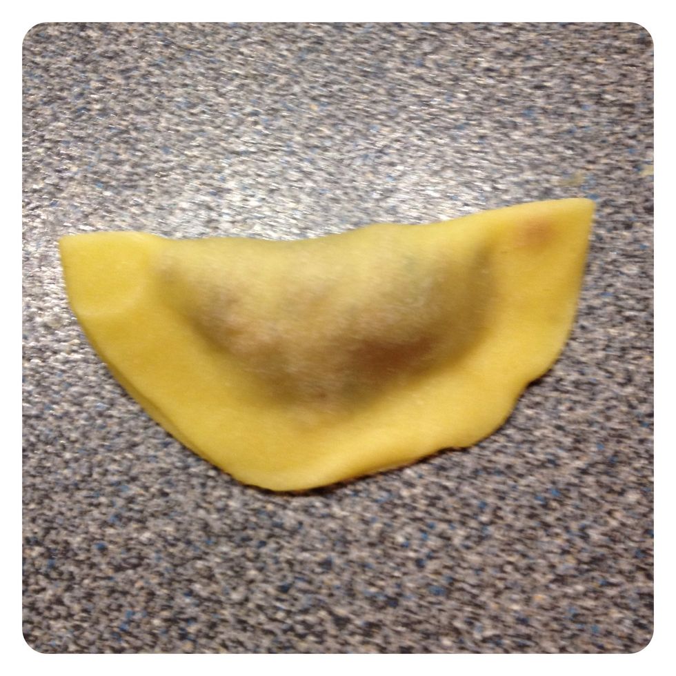 Brush the edges with water, fold the dough over the filling and close the edges to keep the filling inside when boiling later