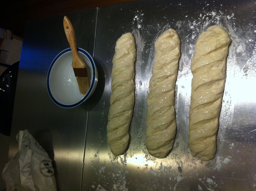 Brush the egg white on the loaves until all of the top surface is covered.