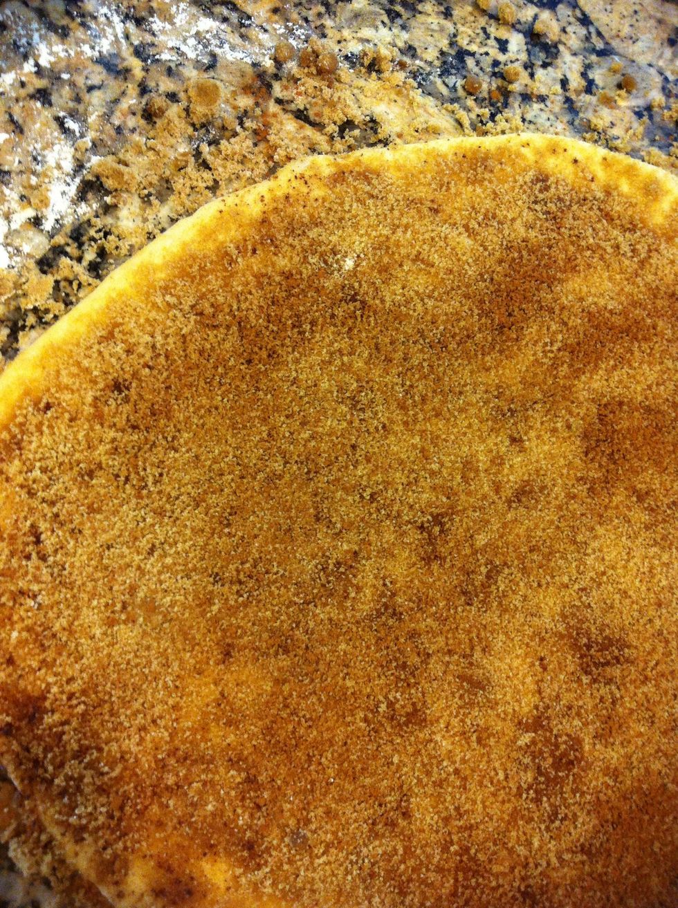 Brush the entire surface with the browned butter. Then add enough brown sugar to coat well. I used a few hand fulls and a good sprinkle of cinnamon. Press this into the buttered dough