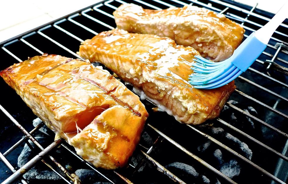 Brush the fillets with the reserved marinade after turning to add flavour and keep it moist.