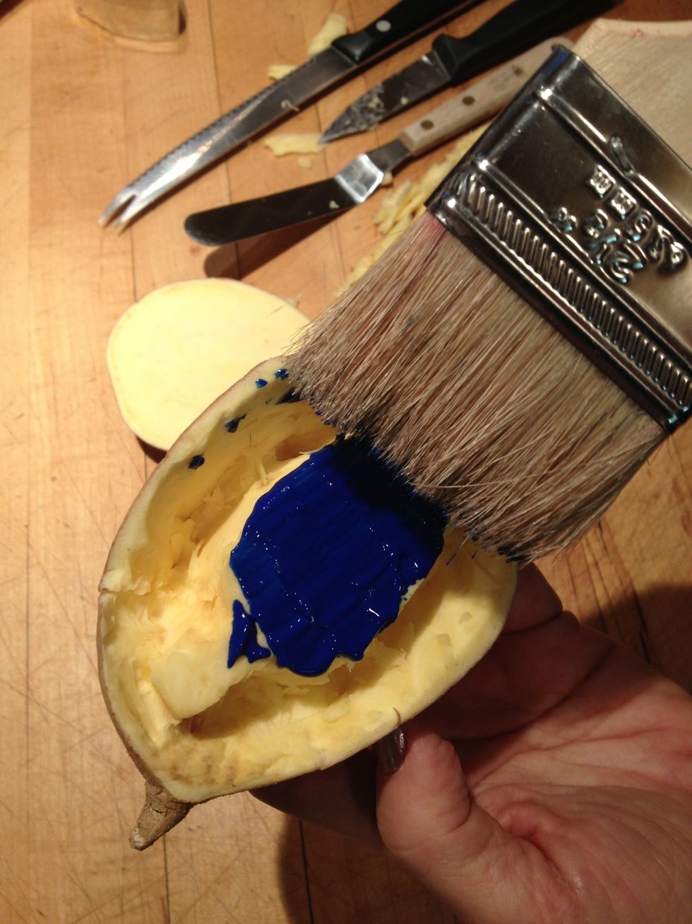 Brush the paint onto the raised design.
