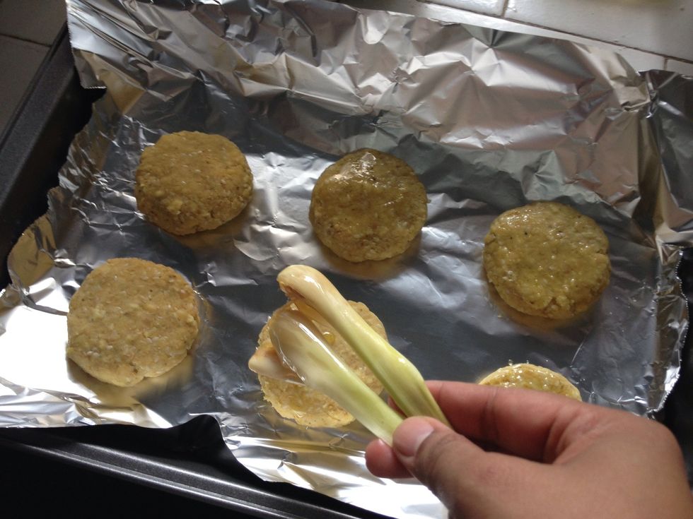 Brush the patty with the olive oil using the lemongrass 'brush'. Do it on each side. Note: do not throw away the lemongrass brush and olive oil mixture in a bowl. We will use it for later